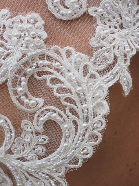 luxury bridal couture studio lace fabric pins hand sewing wedding dress detail